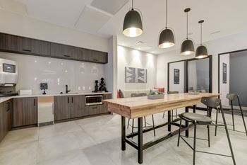 a kitchen and dining area with a wooden table and stools